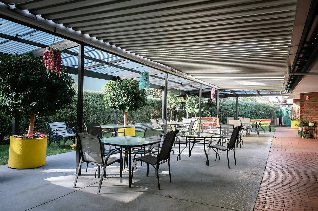 The covered outdoor dining area and gardens at Nexia Aged Care Footscray